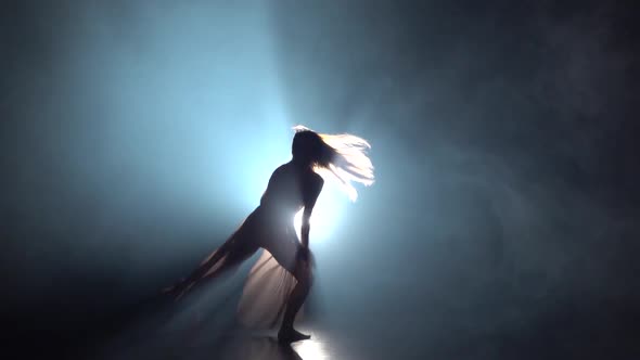 Female Dancing Contemp in Dark Studio Against Spotlight. Slow Motion