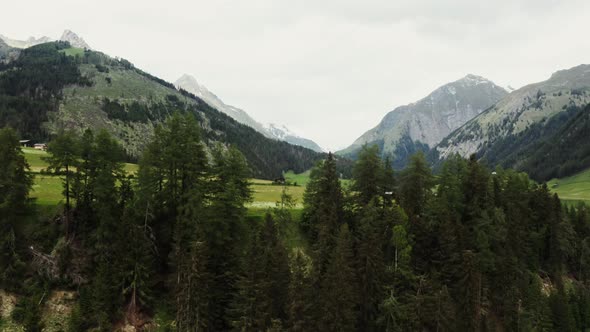 Panoramic View of a Picturesque Mountain Valley with a Village in a Lowland