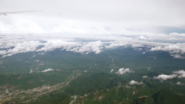 A view of the upper plane window while floating in the air, overlooking the mountains and natural wa
