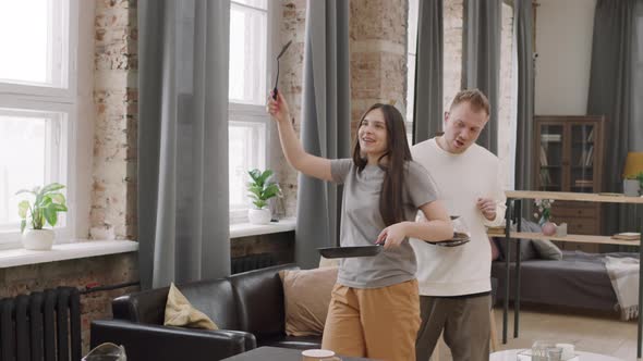 Happy Couple Dancing and Preparing Breakfast