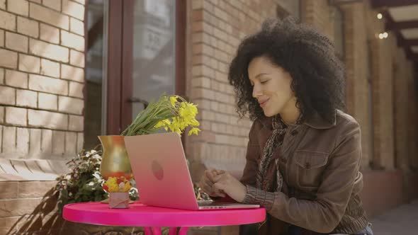 Portrait of Stylish Young African American Woman Talking on Video Call Using Laptop