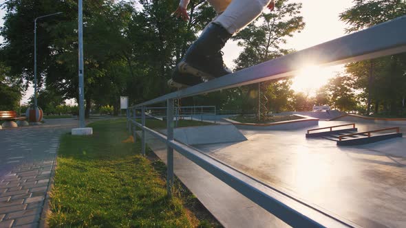 Aggressive Inline Roller Skater Doing Tricks in Concrete Skatepark Outdoors Slow Motion Tracking