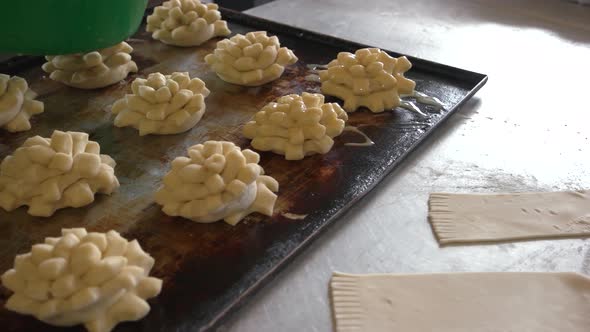 Female Baker Glazing Dough with Yolk