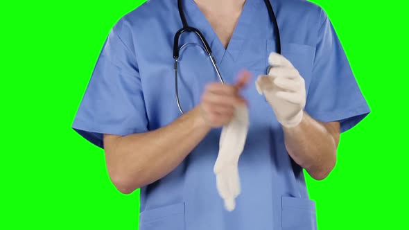 Medical Worker Putting on Medical Gloves. Green Screen. Close Up