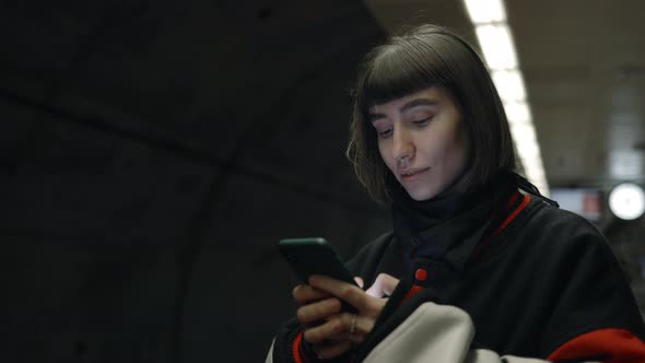 Attractive Woman Using Smartphone While Waiting for Metro