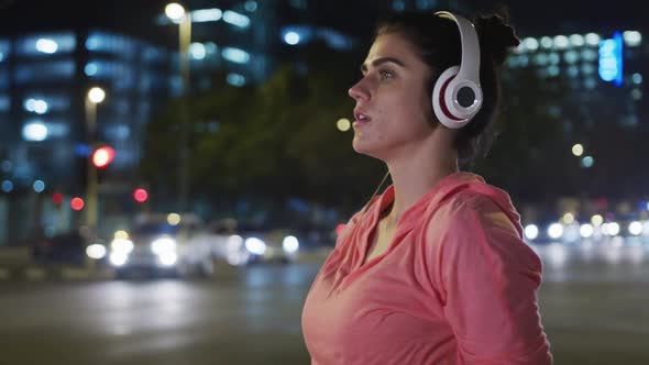 Young woman listening to music before running