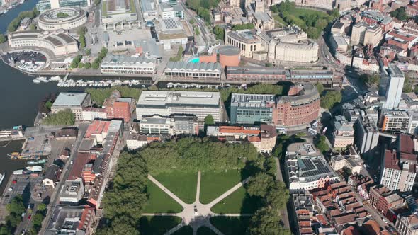 Dolly back pan up drone shot of vibrant central Bristol City UK