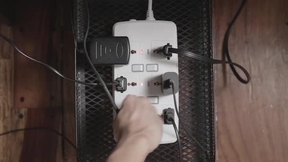 Switching on a power strip with many plugs. Overhead View