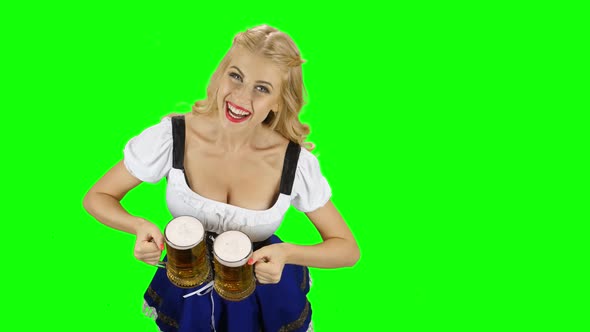 Bavarian Girl in Bavarian Costume Offers Someone a Beer and Smiling. Green Screen