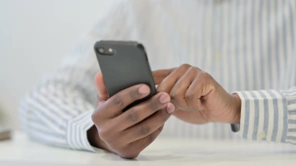 Close Up of African Man Using Smartphone Mobile