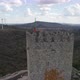 Main keep with Portuguese flag at Castle of Sortelha; aerial orbit - VideoHive Item for Sale