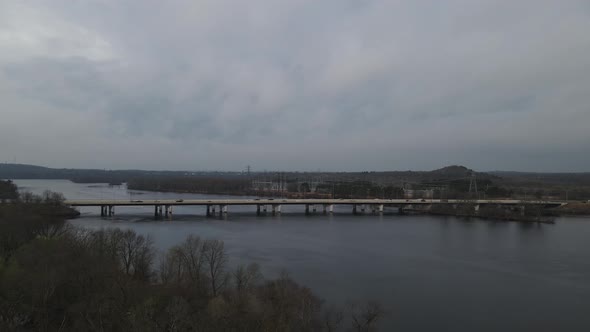 A view of cars passing the bridge over a river in Menomonie, Wisconsin in 4K