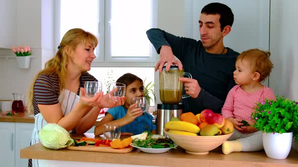 The Family Prepares Smoothies at Home