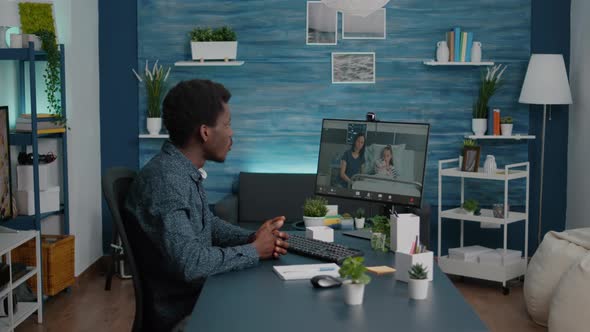 Black Man Talking with Wife About Kid Health While They are Lying in Hospital Ward