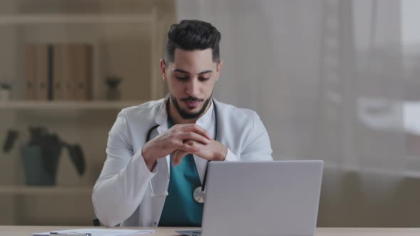 Young Arab Hispanic Medic Therapist Concentrated Doctor Physician Expert Guy Wear White Coat Use