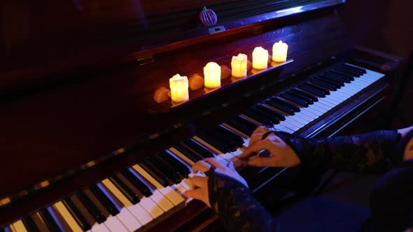 Woman Playing on Vintage Wooden Piano at Halloween