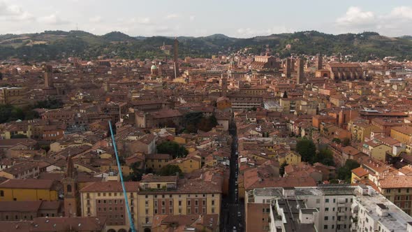 Cinematic view of Bologna city old town, side flying ascend drone view