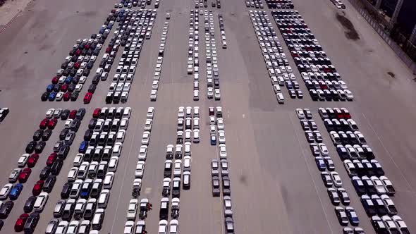 Aerial view of logistics concept commercial vehicles, cars and pickup trucks waiting to be load on t