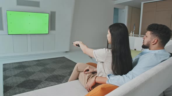 Young Couple Watching TV At Home