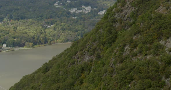 Tilt Down From Bear Mountain to Overhead of Cars Driving on Road