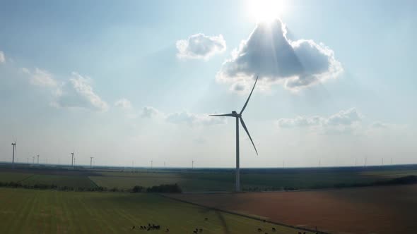 Drone Shot of Wind Generators on Farm Among Fields