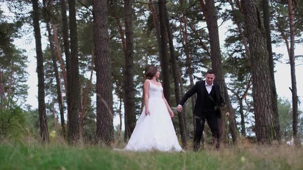 Happy Couple of Brides Walking in the City Park Wedding Day