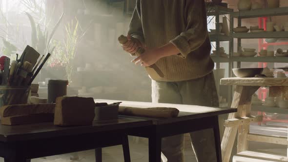 Woman Is Shaping Raw Clay In Pottery Studio