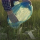 Volunteer a Man is Engaged in Cleaning Plastic Garbage in Park on Grass - VideoHive Item for Sale