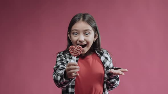 Little Girl is Happy with Heart Caramel on a Stick Surprised Emotion