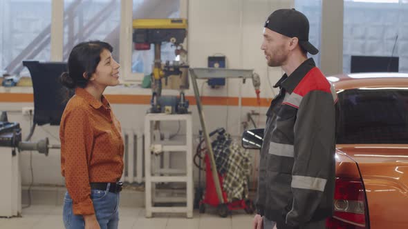 Mechanic Giving Handshake to Female Client