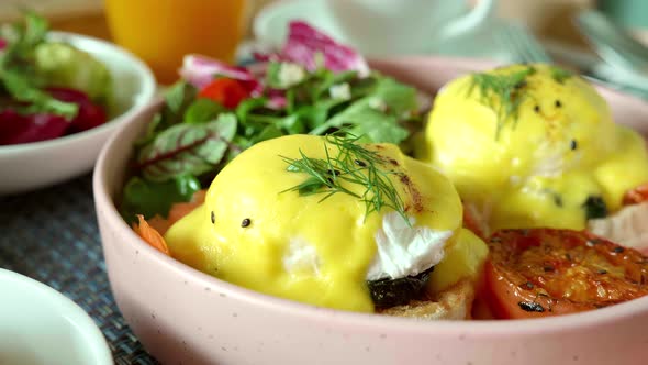 Closeup of Eggs Benedict with Salmon on Baked Muffin with Grilled Vegetable