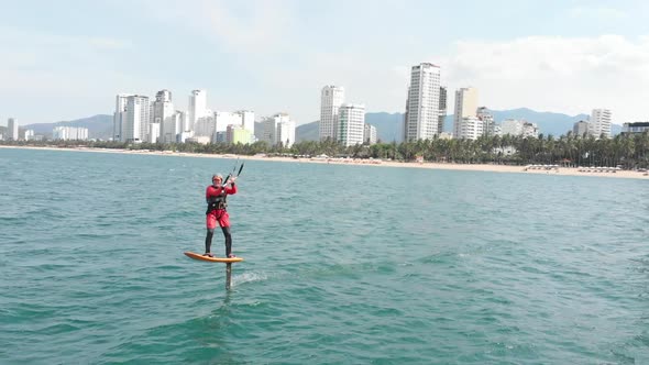 Professional Kite Surfer on the Sea Wave, Athlete Showing Sport Trick Jumping with Kite and Board in