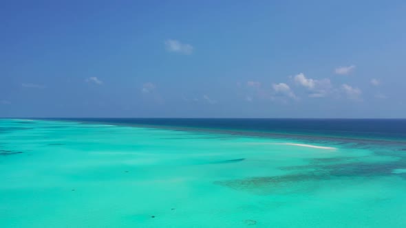 Aerial drone panorama of idyllic shore beach holiday by blue lagoon and white sand background of a d