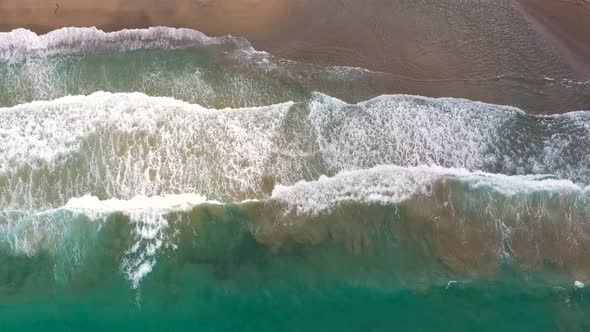 Aerial View of the Mediterranean Coast Waves Reach the Deserted Sandy Beach