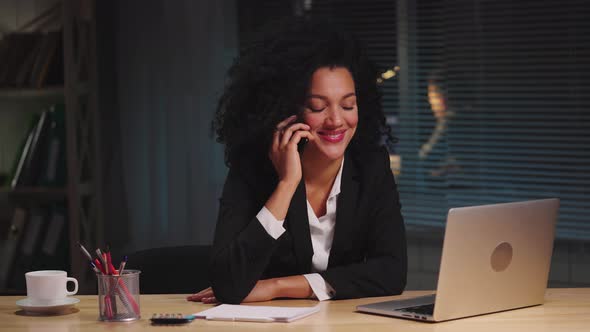 Portrait of African American Woman in Business Suit Talking on Smartphone