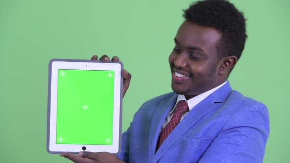 Face of Happy Young African Businessman Showing Digital Tablet