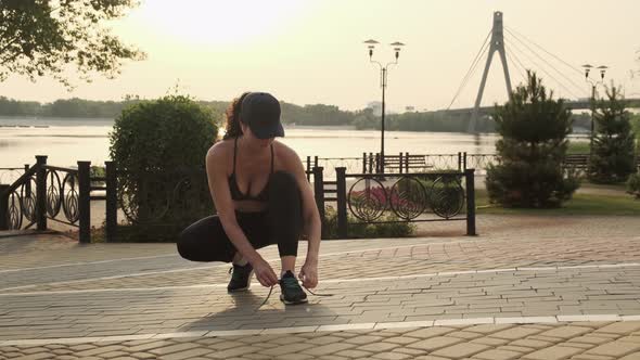 Female Sport Fitness Runner Getting Ready for Jogging Outdoors on Way