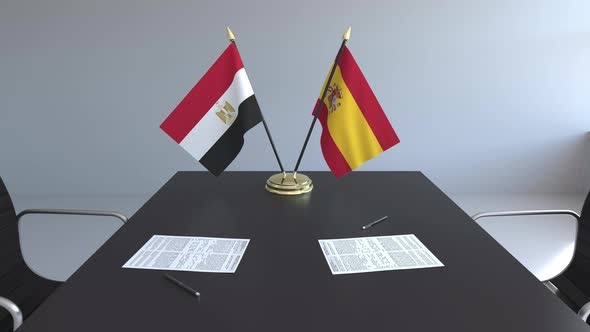 Flags of Egypt and Spain and Papers on the Table