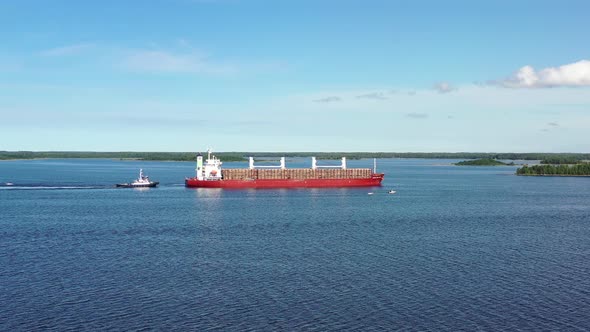 Flying Towards Large Ship Loaded With Timber