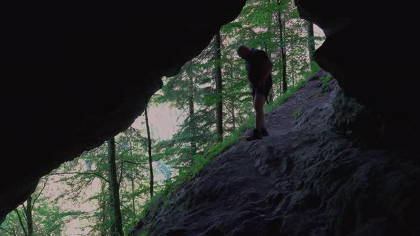 Hiker relax and read books outdoor, in a cool cave