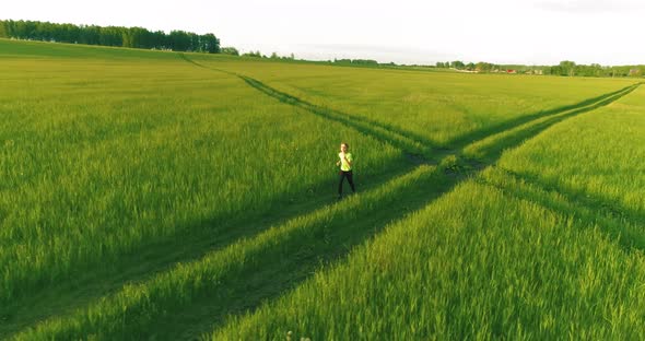 Sporty Child Runs Through a Green Wheat Field, Evening Sport Training Exercises at Rural Meadow