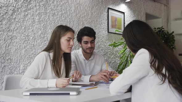 Young Creatives Brainstorming Ideas Together at Work