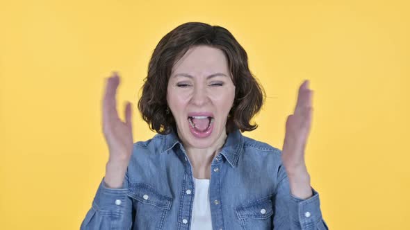 Screaming Old Woman Shouting on Yellow Background