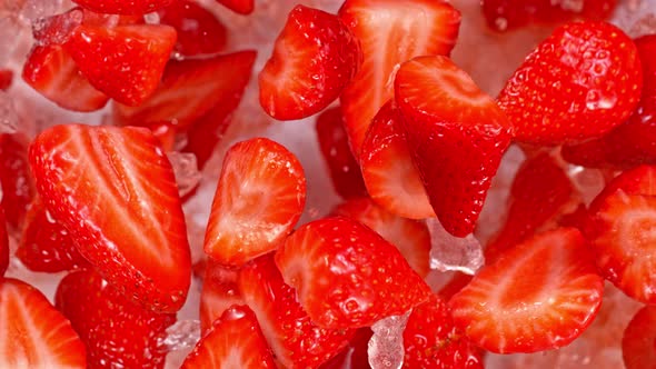 Super Slow Motion Shot of Fresh Strawberries and Crushed Ice Flying Towards Camera at 1000Fps