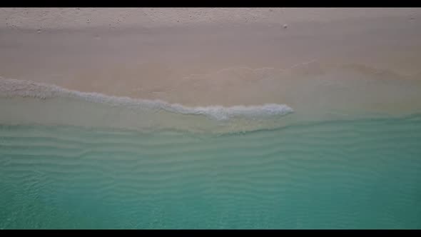 Aerial drone shot landscape of paradise shore beach lifestyle by blue ocean with white sandy backgro