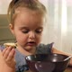 Preschool girl sitting at a table eats soup. Close-up. - VideoHive Item for Sale