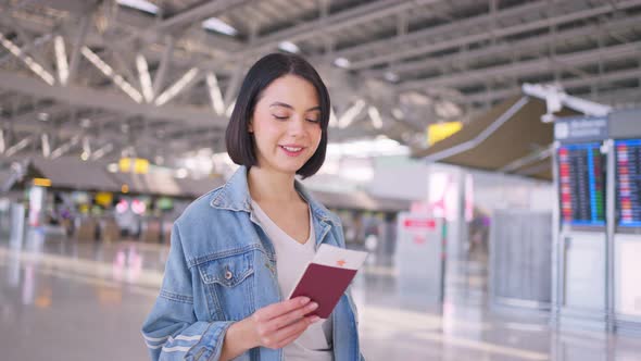 Asian beautiful woman passenger traveler walking in airport terminal to boarding gate to airplane.