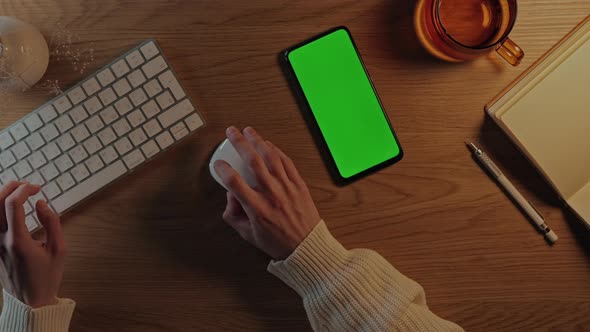 Woman Using Green Screen Mobile and Typing on Keyboard