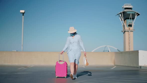 Slow Motion Stylish Traveler in the Airport with Dispatcher Tower on Background