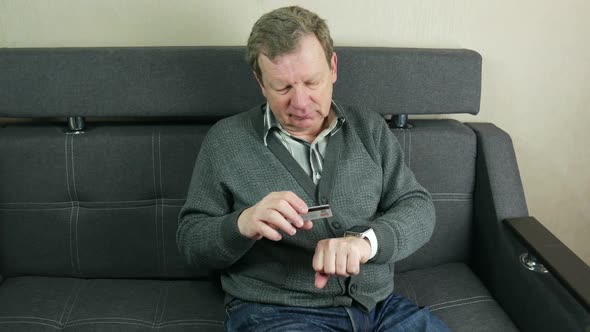 Elderly Man Uses Modern Smart Watch And Credit Card